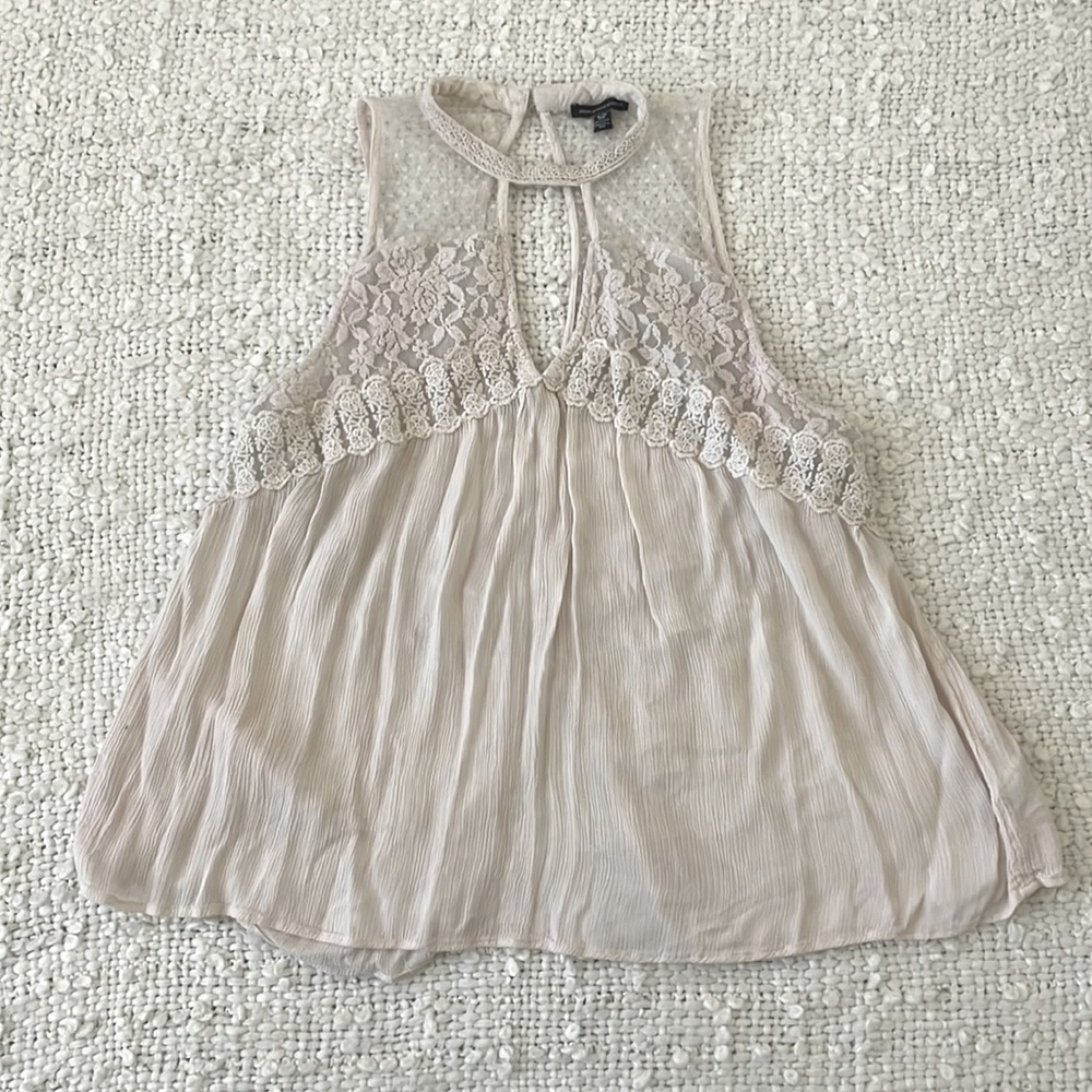 Lace, see through tank. Very cute and flowy. Lace is in great condition